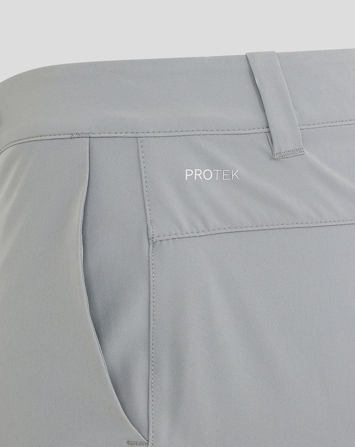 Close up of waistband on light gray NZC golf shorts showing PROTEK branding