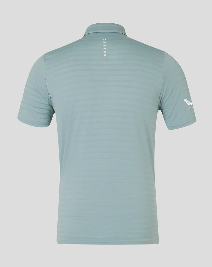 Back view of NZC Club Essential Golf Polo in light teal with vertical CASTORE lettering along the neck