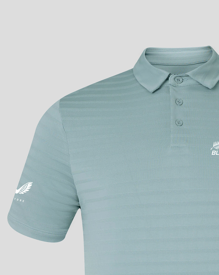 Close-up of sleeve and chest on NZC Club Essential Golf Polo in light teal with subtle stripes and sleeve logo