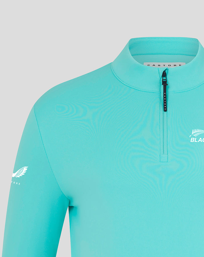 Close up of turquoise NZC Club Classic 1/4 zip top showing collar zip and chest logo
