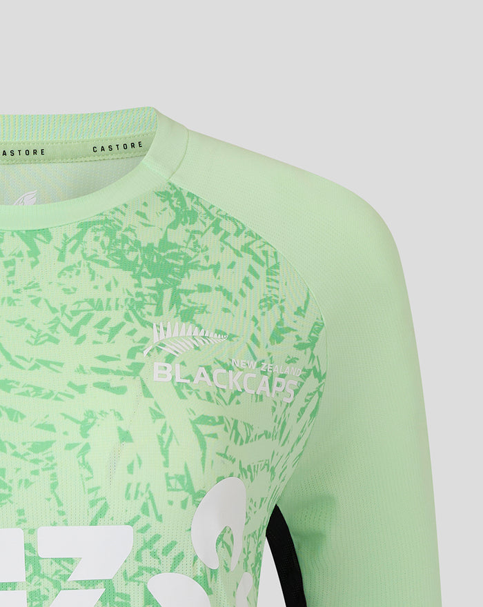 Shoulder and neckline detail of the mint green training long sleeve top with textured fabric and seam lines.