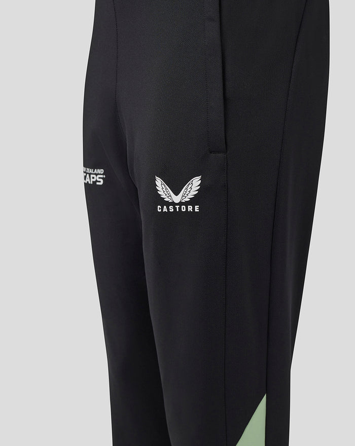 Close up of black training knit pants with white Castore wing logo on the thigh