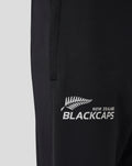 Close up of black training pants showing New Zealand BlackCaps logo on the thigh