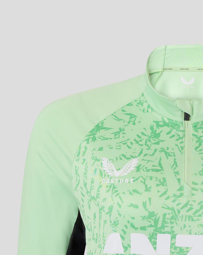 Close-up of mint green womens 25/26 training midlayer top showing collar and zipper with a printed pattern