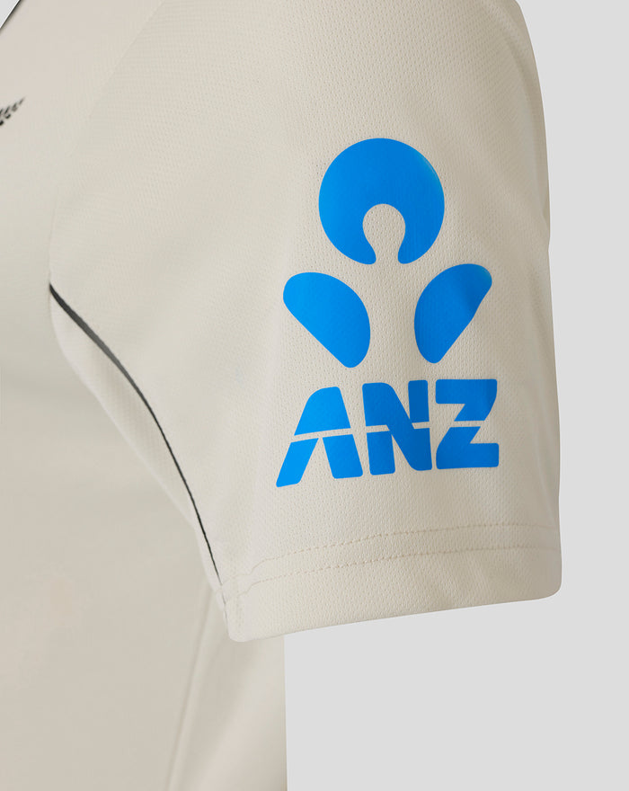 Beige short sleeve shirt with blue ANZ logo on the sleeve