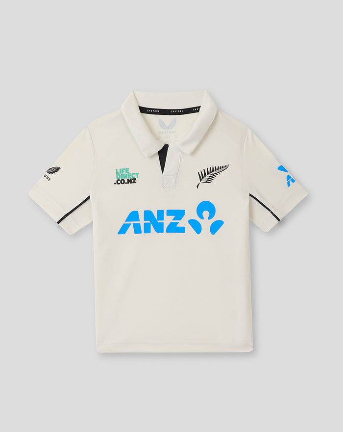 Front view of ivory Infant 25/26 Test Short Sleeve Shirt polo featuring blue ANZ logo and sponsor graphics