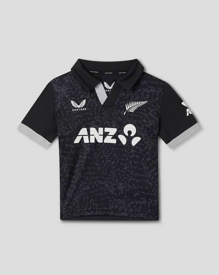 Front view of an infant black patterned short sleeve shirt with a large white logo