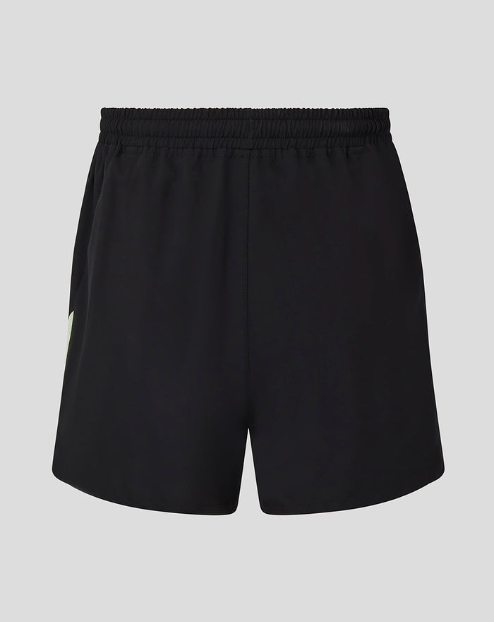 Back view of black training shorts with elastic waistband and mint green side panel.