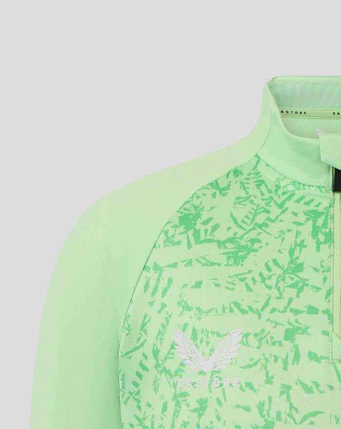 Close-up of upper front of junior mint green training midlayer top showing textured pattern and white wing logo