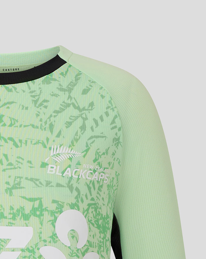 Shoulder and chest view of the mint green junior training T shirt featuring the leaf pattern and Black Caps branding.