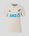 Junior beige polo shirt with blue ANZ logo across the chest and a fern emblem