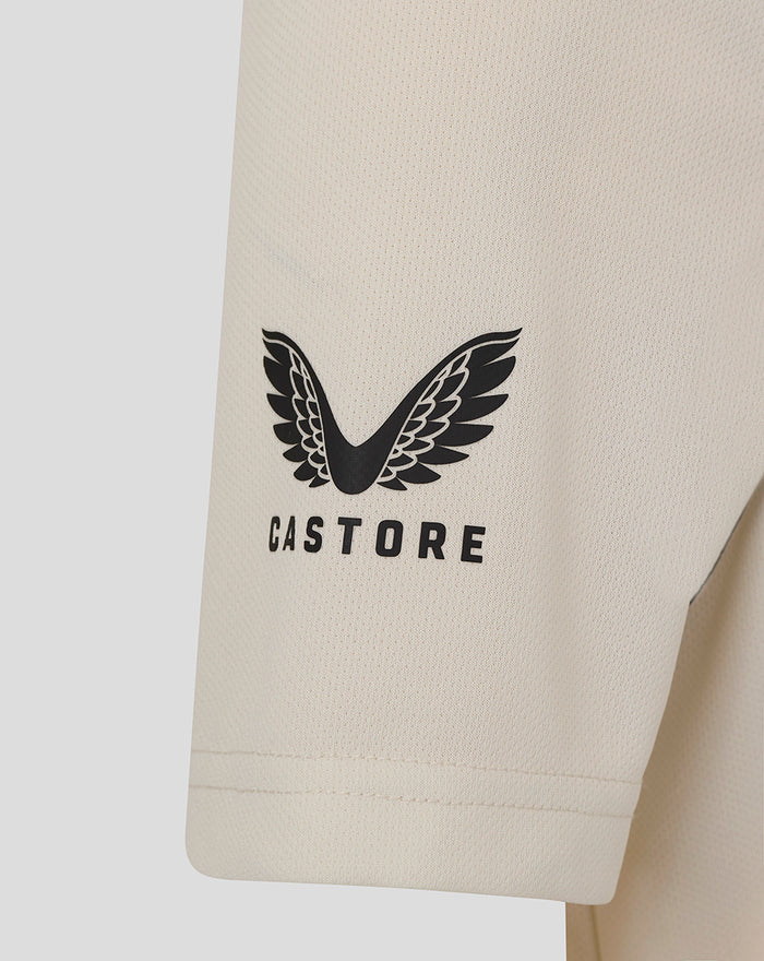 Beige polo sleeve with large black fern logo and Castore branding on the lower sleeve