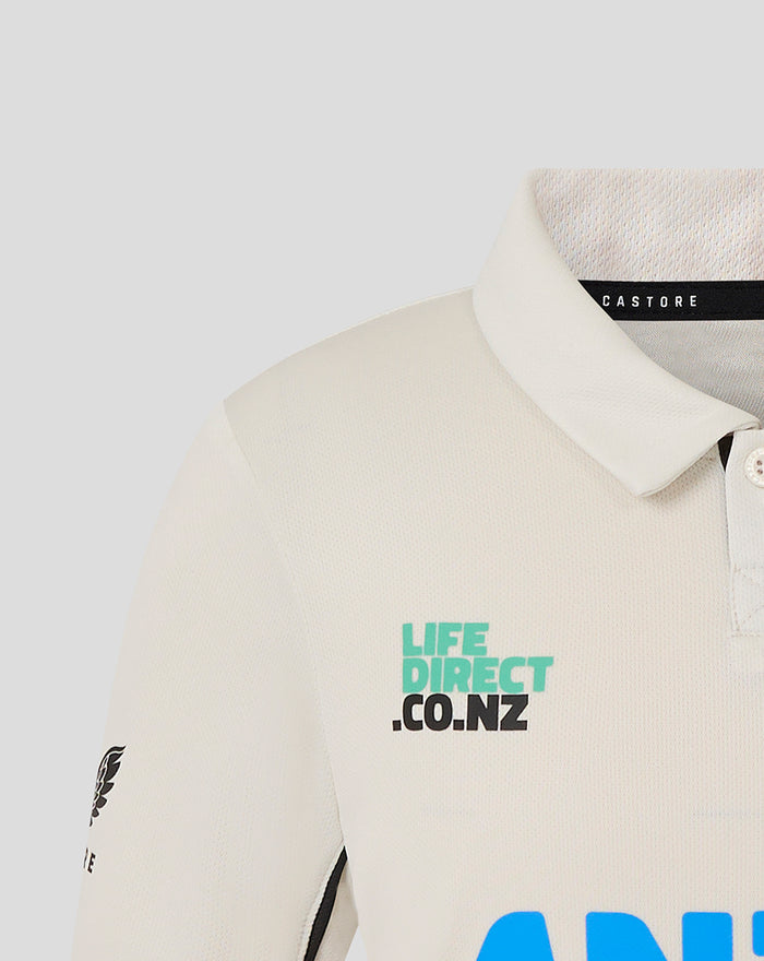 Beige junior short sleeve polo shirt with teal LIFE DIRECT CO.NZ logo on chest
