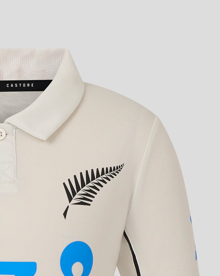 Beige polo collar close up showing Castore label and black fern logo on chest