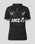 Front view of junior black ODI short sleeve polo shirt with an abstract pattern and white sponsor logos.