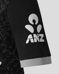 Close-up of the black sleeve showing a large white ANZ logo and a light gray cuff.