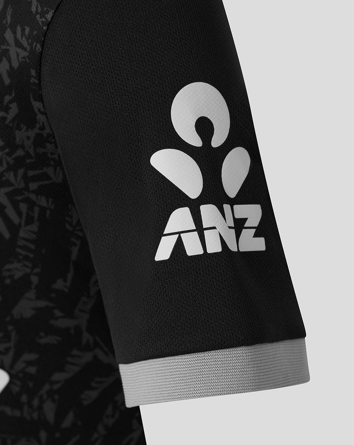 Close-up of the black sleeve showing a large white ANZ logo and a light gray cuff.