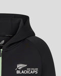 Close up of black hoodie showing Castore branding at the neckline and a white ANZ emblem on the chest.