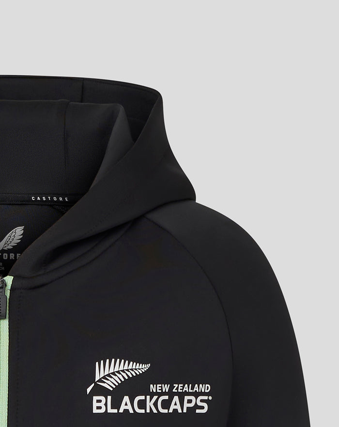 Close up of black hoodie showing Castore branding at the neckline and a white ANZ emblem on the chest.