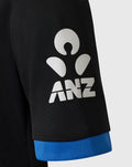 Close up of black sleeve with white ANZ logo and blue cuff.