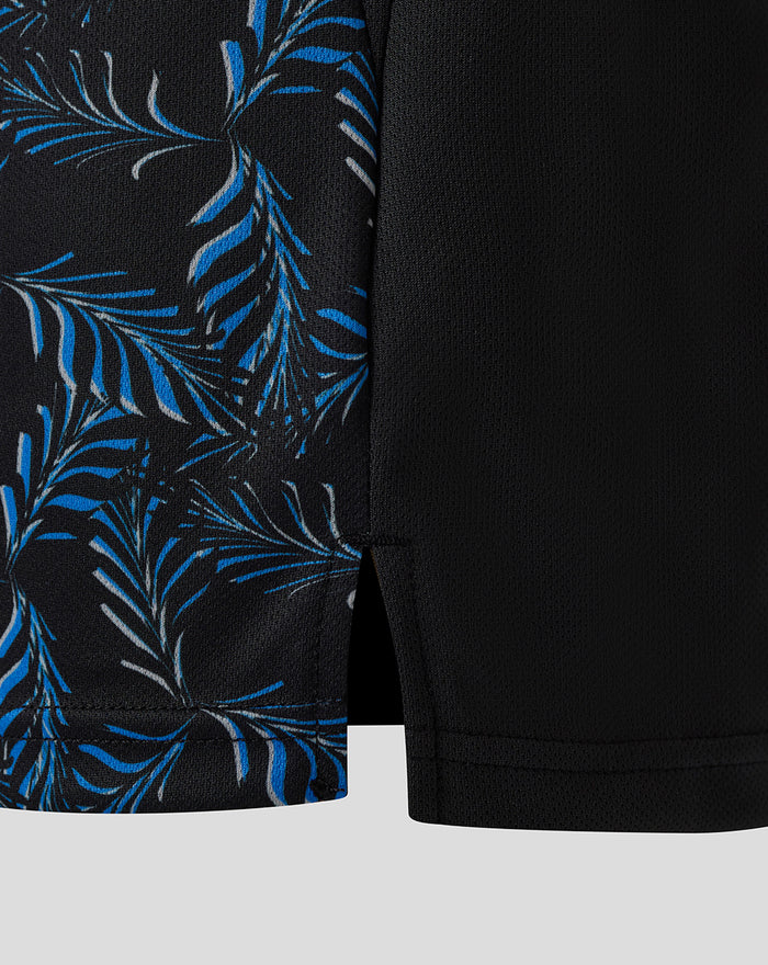 Side view of black Junior T20 shirt featuring a blue palm leaf print panel and vent at the hem.