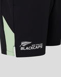 Bottom hem of black training shorts with mint green side panel and Blackcaps logo.