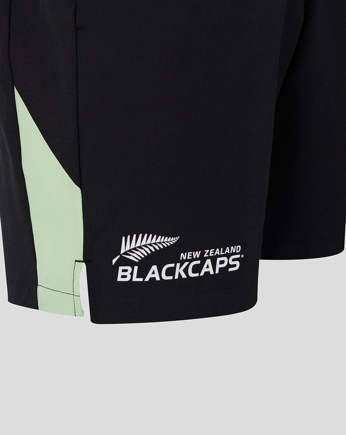 Bottom hem of black training shorts with mint green side panel and Blackcaps logo.