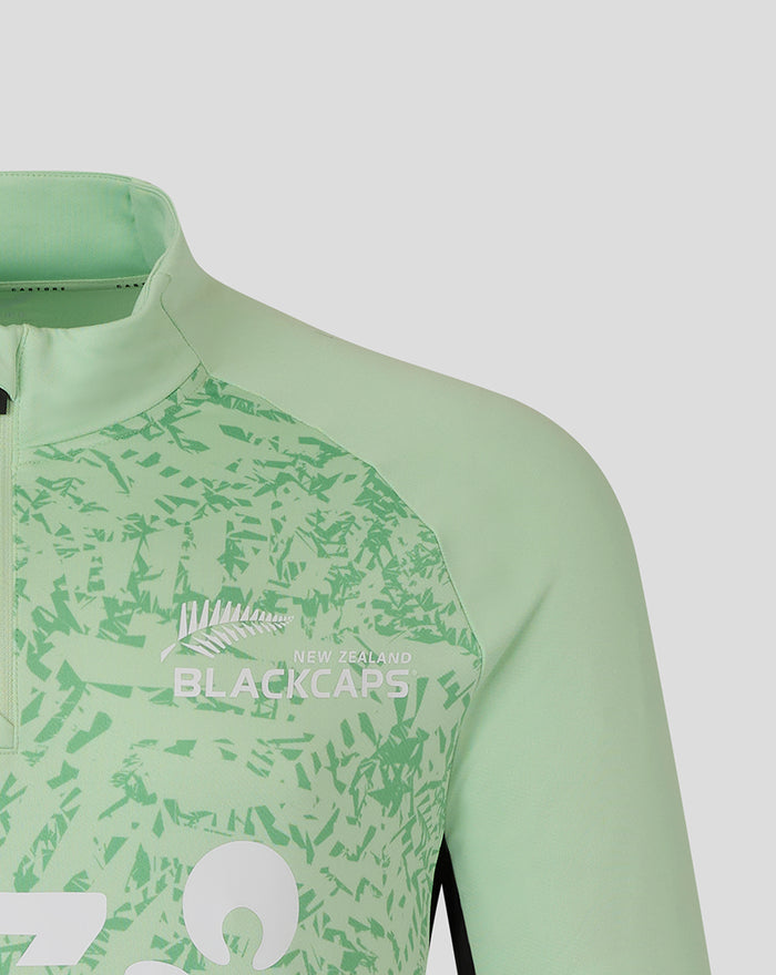 Close up of chest area with Blackcaps branding and bold white letters on patterned mint green fabric