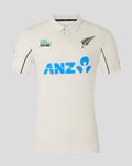 Front of Mens 25/26 Test Short Sleeve Shirt in off white with large blue ANZ logo and fern motif