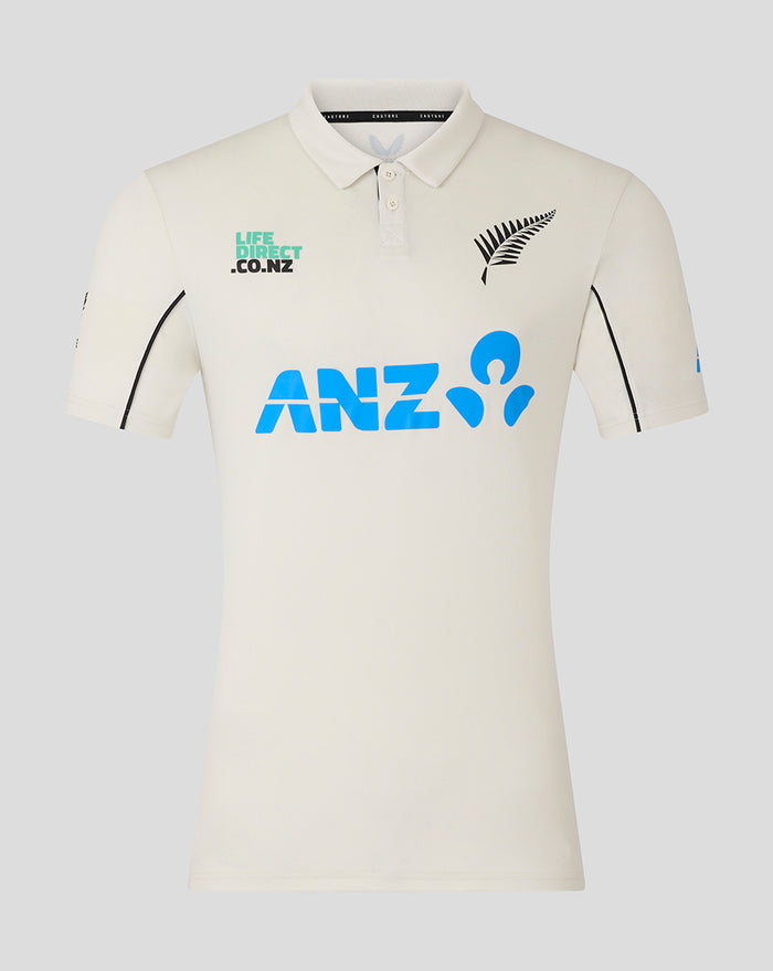 Front of Mens 25/26 Test Short Sleeve Shirt in off white with large blue ANZ logo and fern motif