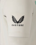 Close-up of cream polo sleeve with blue ANZ logo and Castore wing branding visible on the chest area.