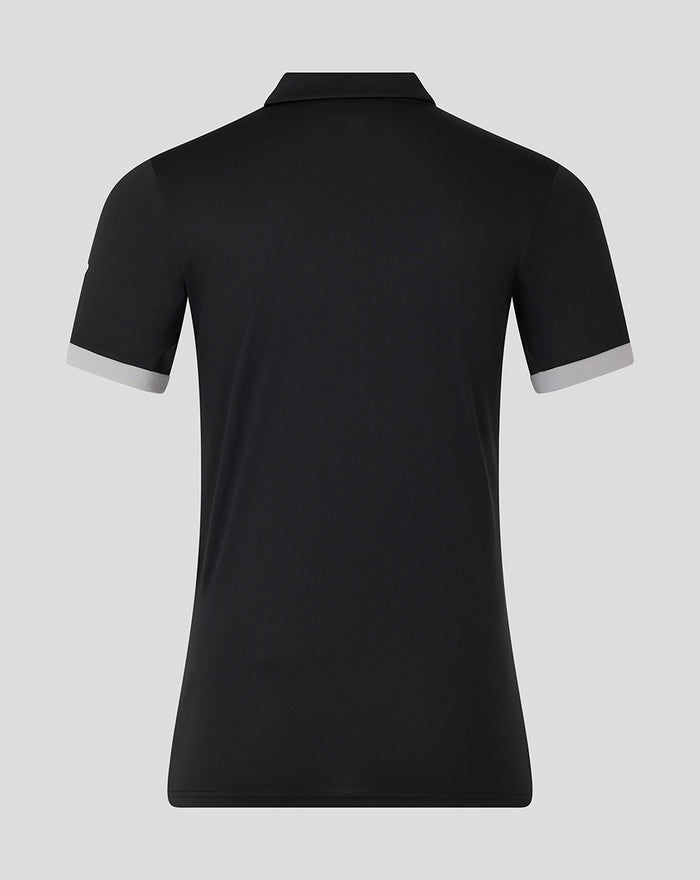 Back view of a black women's ODI short sleeve polo shirt with light gray cuff trim.