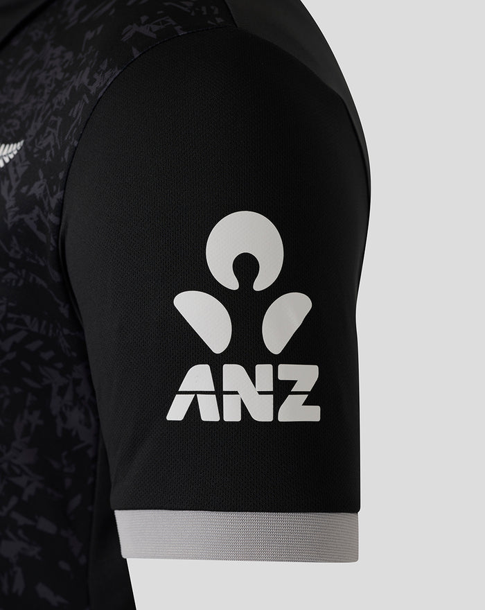 Sleeve close up featuring ANZ logo on black fabric with a light gray cuff