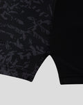 Lower side view of the black camo ODI shirt showing textured fabric and a light gray sleeve cuff