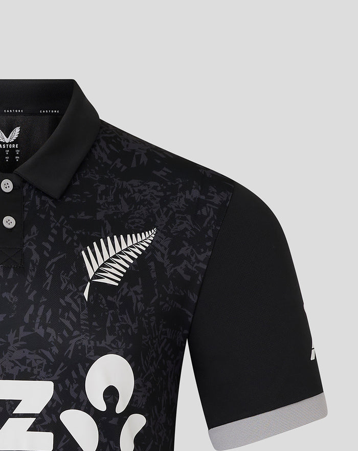 Shoulder and chest area of the black ODI shirt featuring a dark camo pattern and a white fern logo