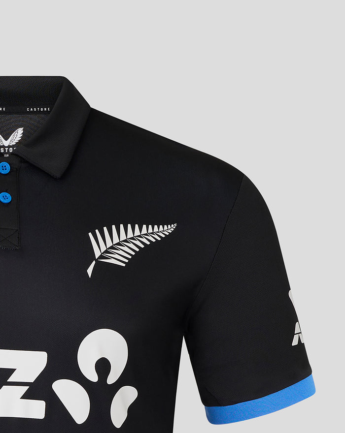 Close-up of black Womens T20 25/26 Short Sleeve Shirt chest area with white fern logo and blue cuff.