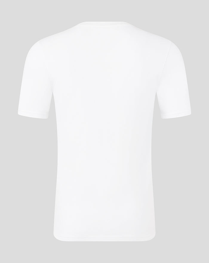 Back view of a plain white short sleeve T shirt on a gray background.