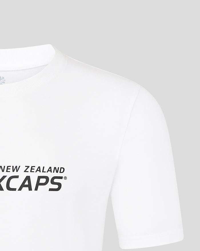 White tee with black New Zealand CAPS graphic across the chest.