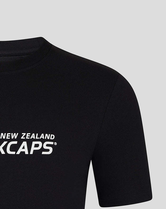 Black Core Caps Tee close up of the shoulder with partial white BLACKCAPS lettering on the chest