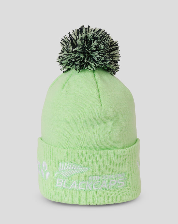 Adult lime green knit beanie with a black and white fluffy pom pom on top